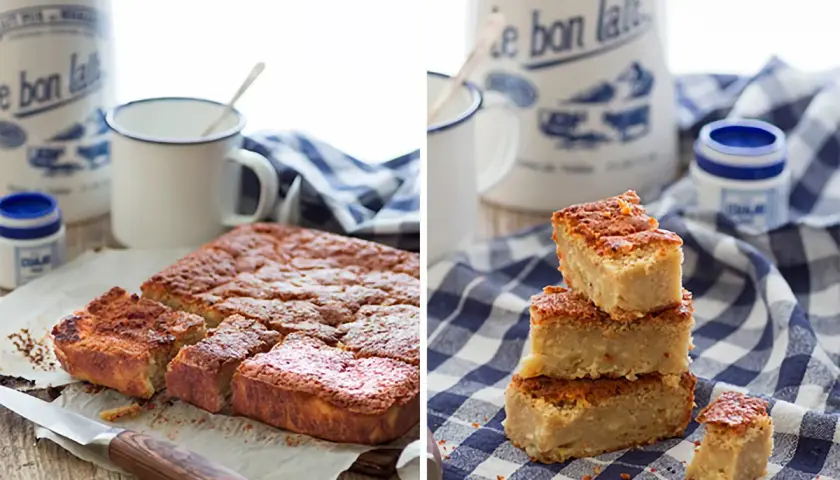 Deliciosa quesada pasiega recién horneada, cortada en porciones y apilada sobre un mantel de cuadros.