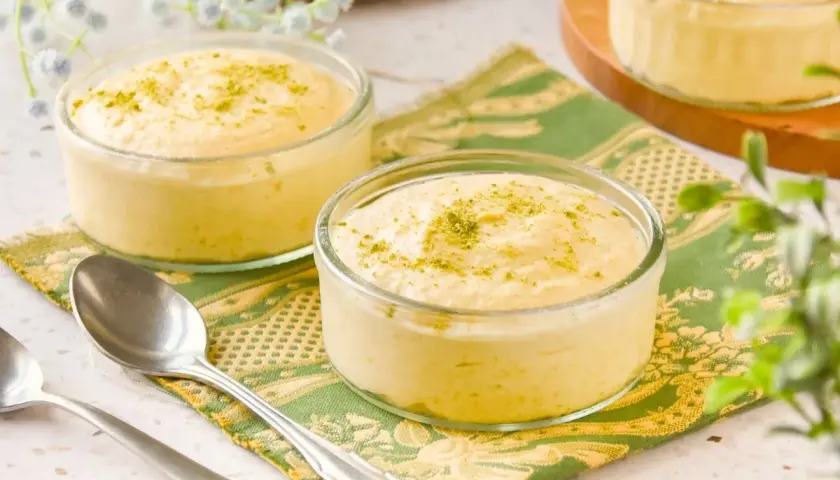 Delicioso mousse de mango en copas de cristal, espolvoreado con ralladura verde.