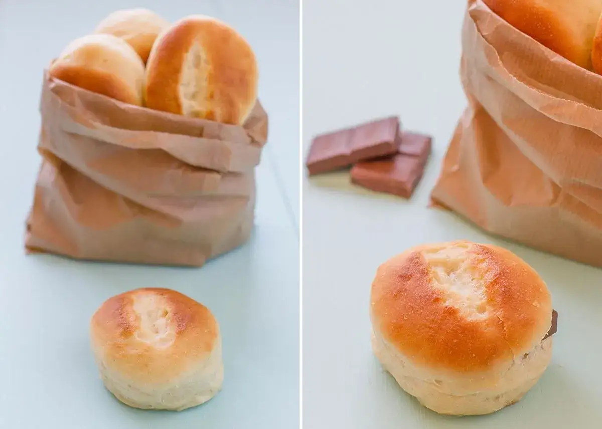 Pan de leche receta: bollos dorados en bolsa de papel y uno abierto con chocolate.